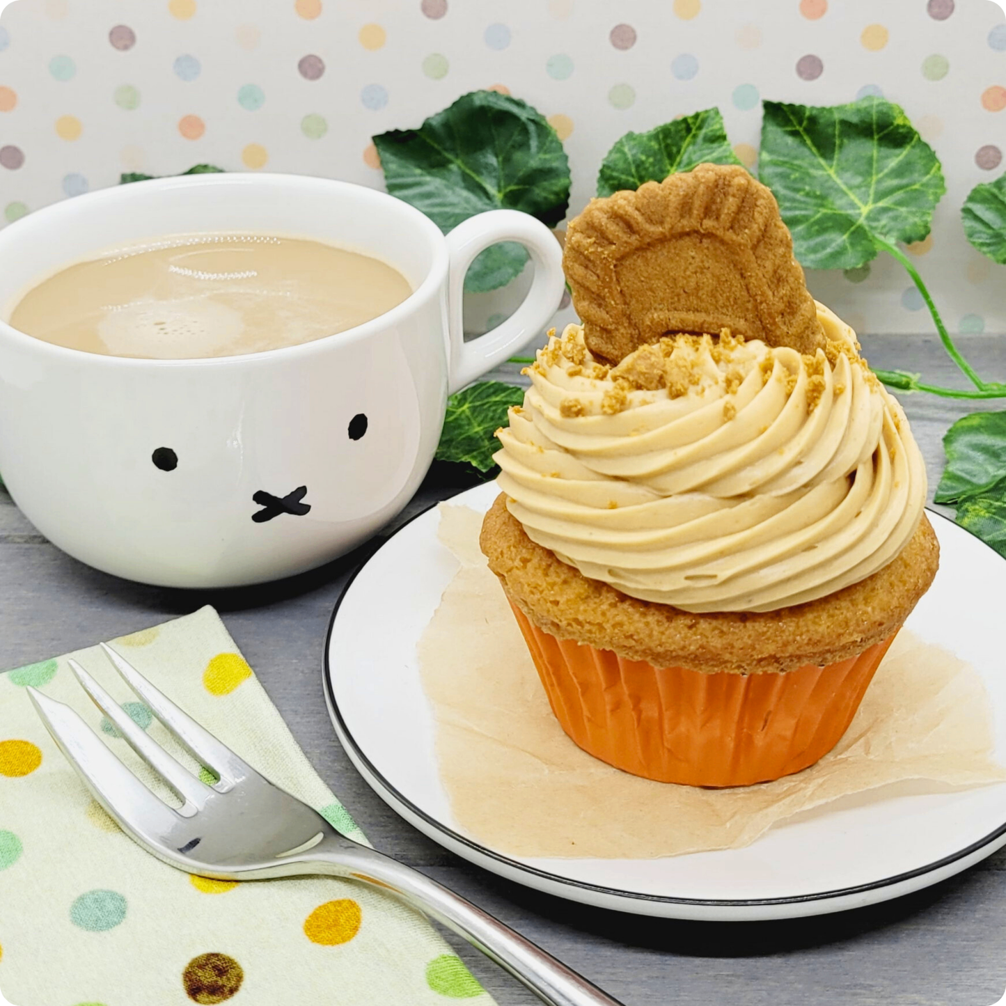 Lotus Biscoff Cupcake geserveerd op een bord met een kop koffie, perfect voor een zoete pauze.